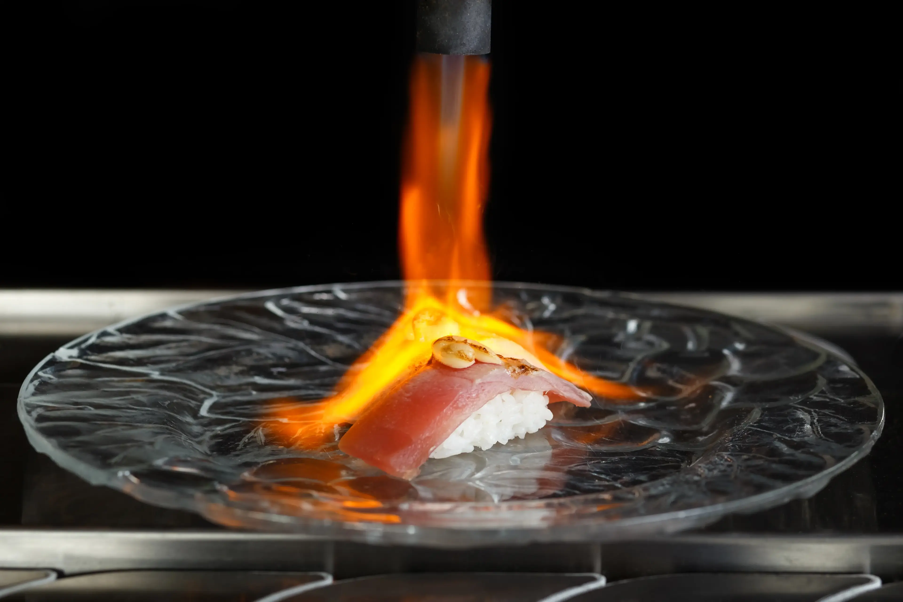 Chef torching nigiri behind the sushi counter at Zen Sushi & Bar, Bellingham